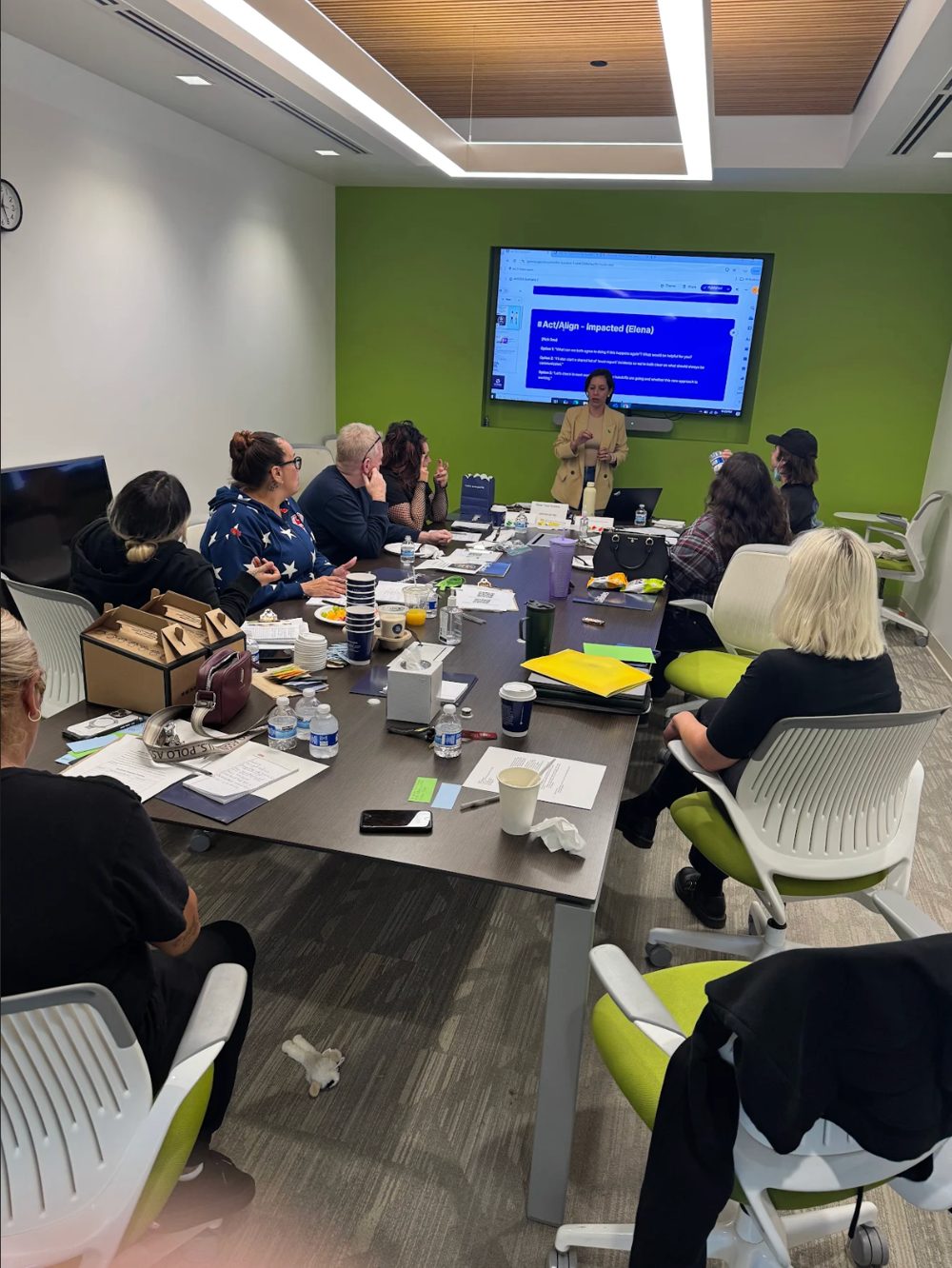 Dr. Isa Karabed leading a leadership strategy session with nonprofit leaders around a conference table.