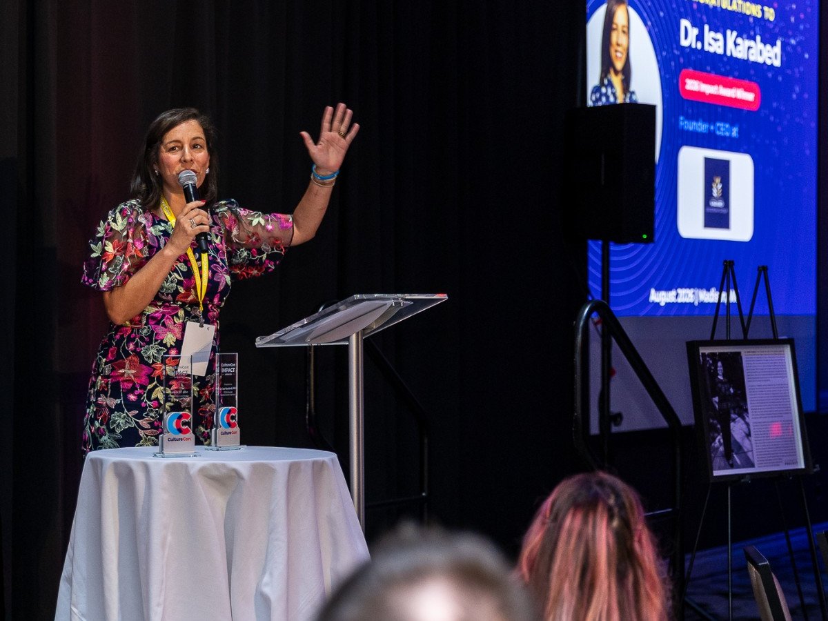 Dr. Isa Karabed accepting the 2026 CultureCon Impact Award on stage